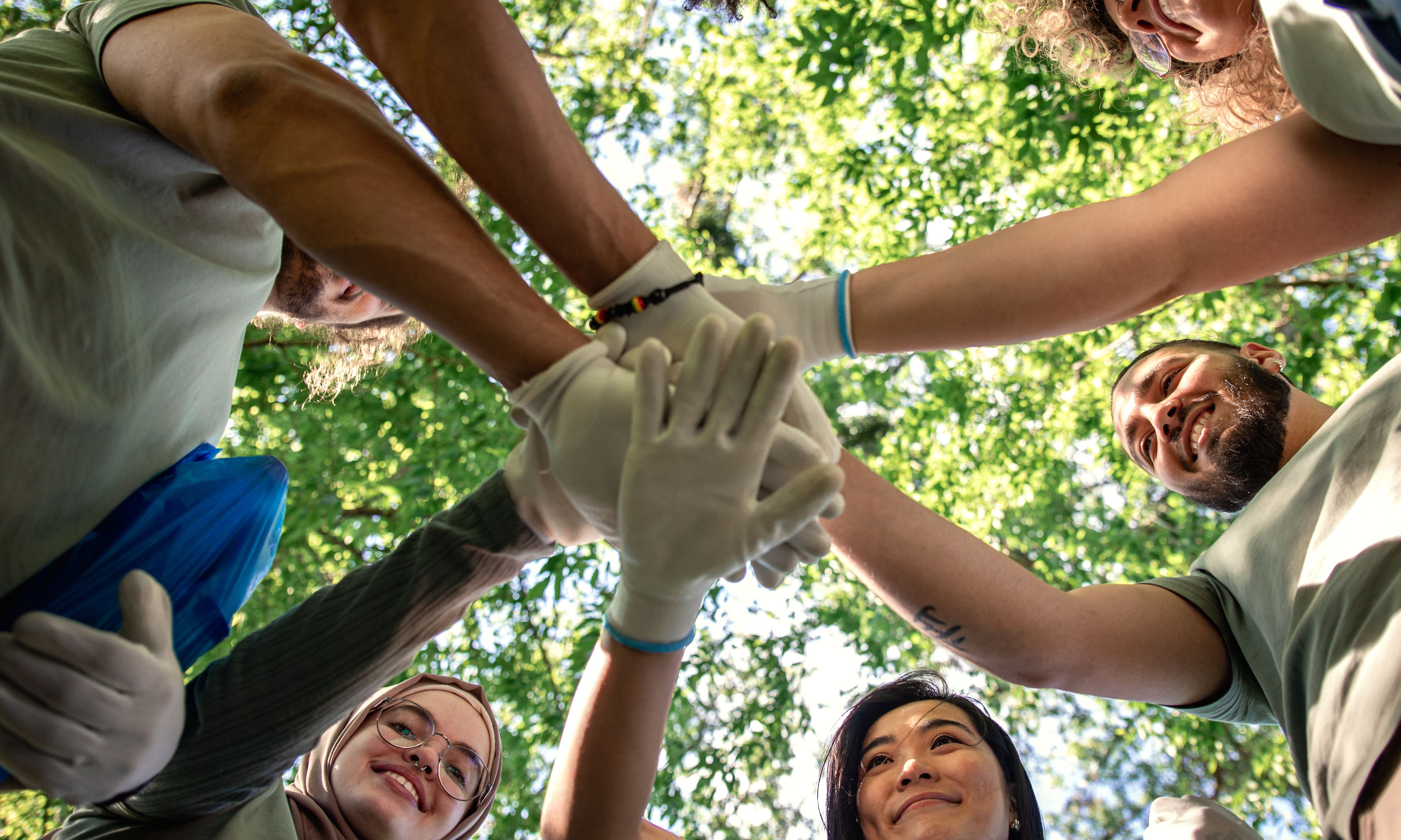 Image of a team with hands in a circle